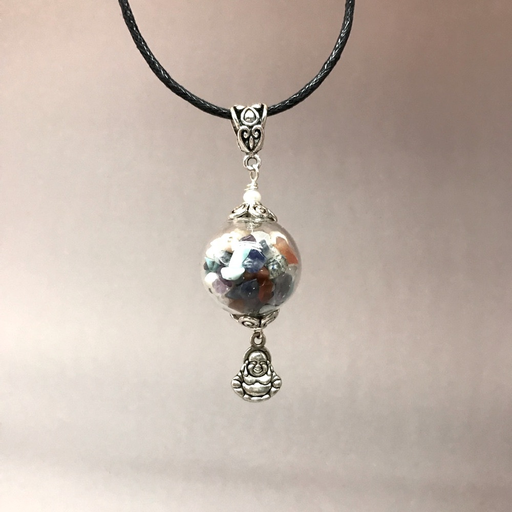 Talisman necklace, glass ball pendant full of healing crystals.